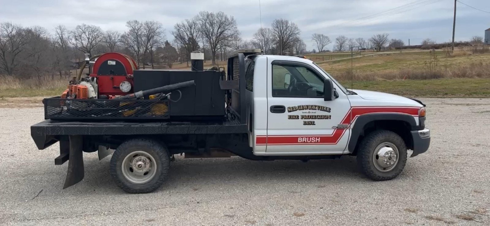 a white brush truck in a parking lot