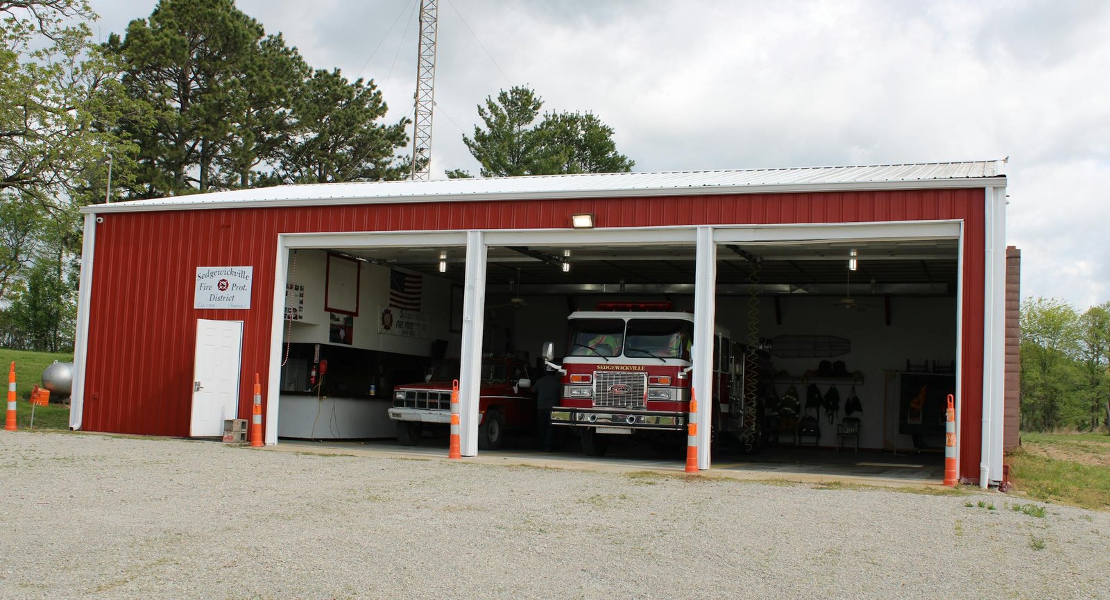 A 3 door fire station with a walk through door on the left side